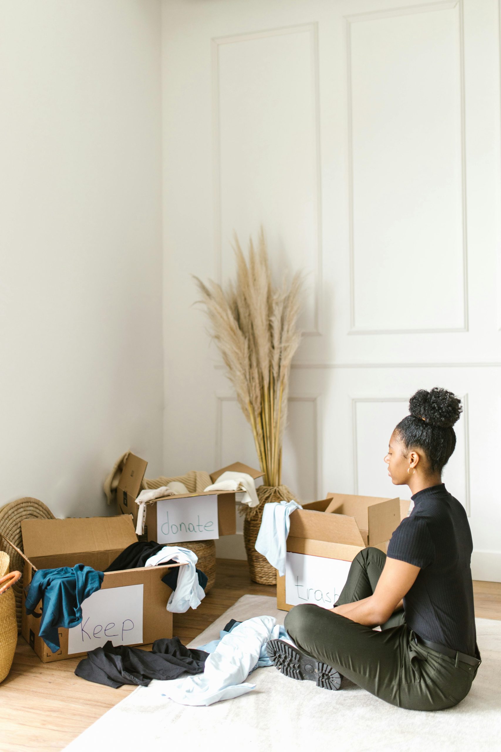 Woman Sorting Downsizing Photo by RDNE Stock project: https://www.pexels.com/photo/woman-sitting-on-a-rug-sorting-clothes-8581019/